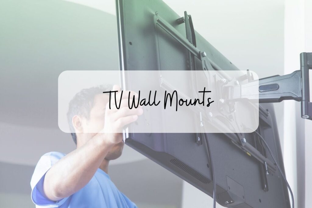 man wall mounting a tv