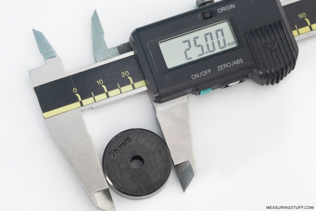 digital caliper measuring a 25mm washer