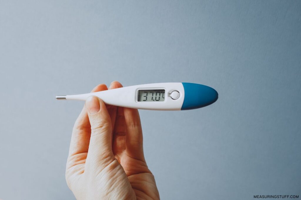 digital thermometer showing 37.0 degrees