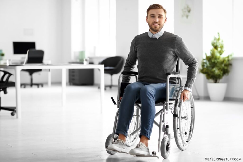 man sitting in a light weight wheelchair in an open office