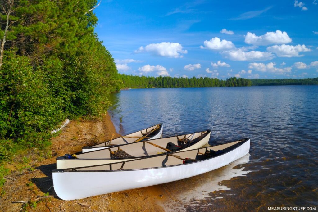 trio of canoes on the shore used to reference how long 30 meters is
