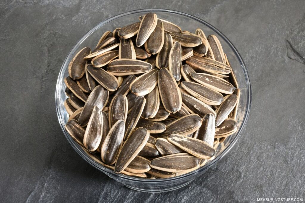 sunflower seeds in a bowl used to reference how much half a gram weighs