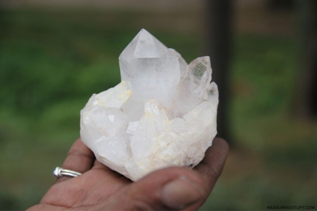 holding a sample of natural quartz