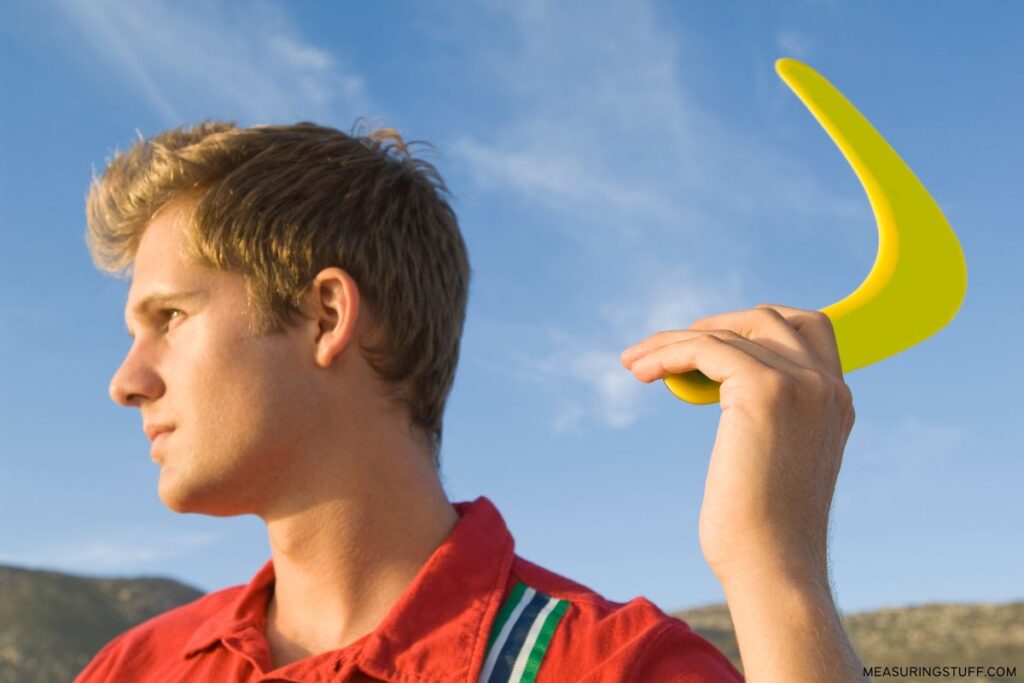 man throwing a plastic boomerang