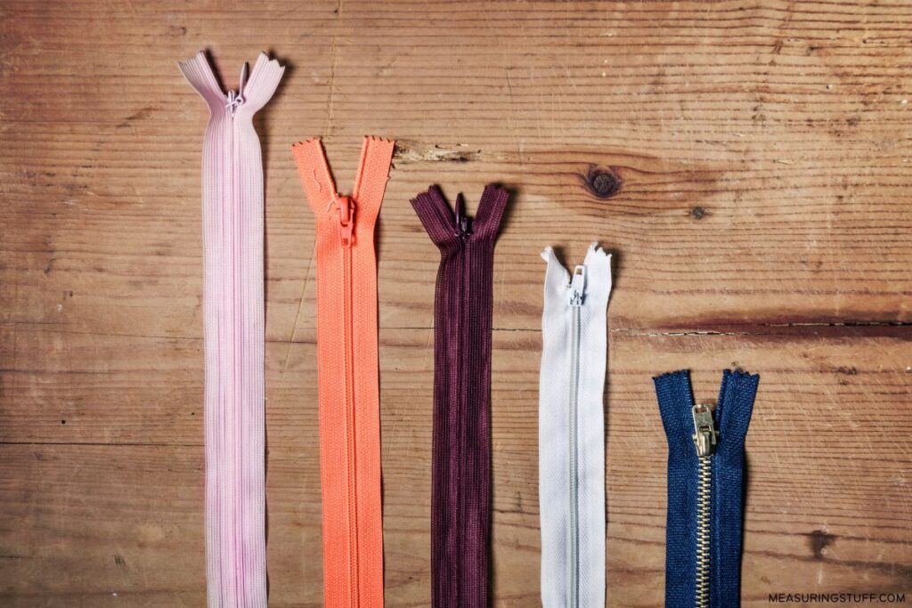 multiple zipper lengths on wood background