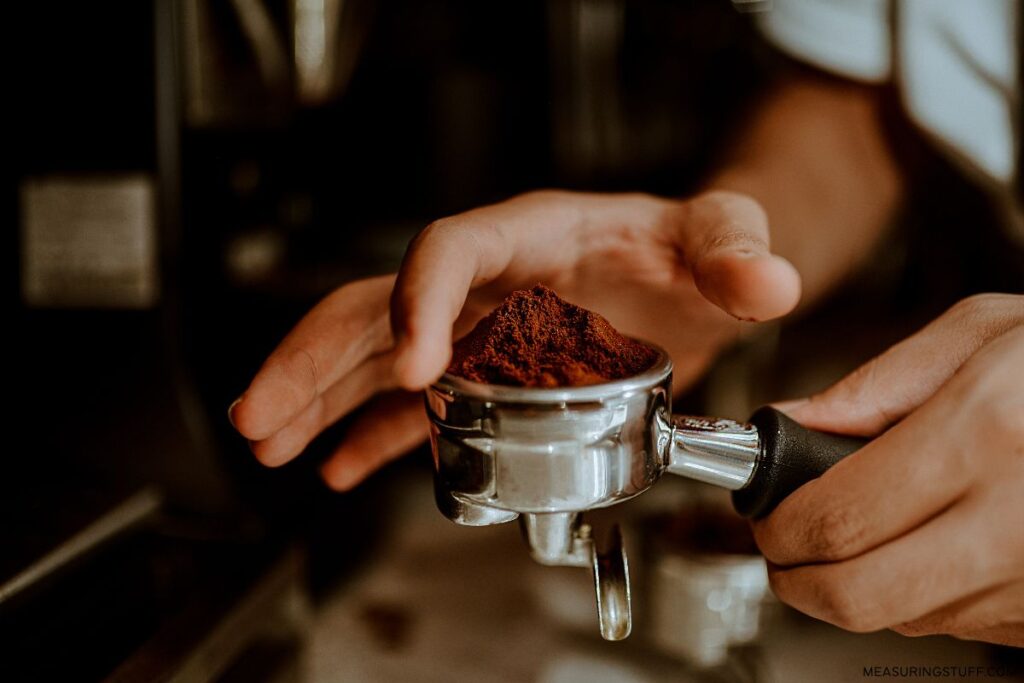 barista scooping coffee grounds