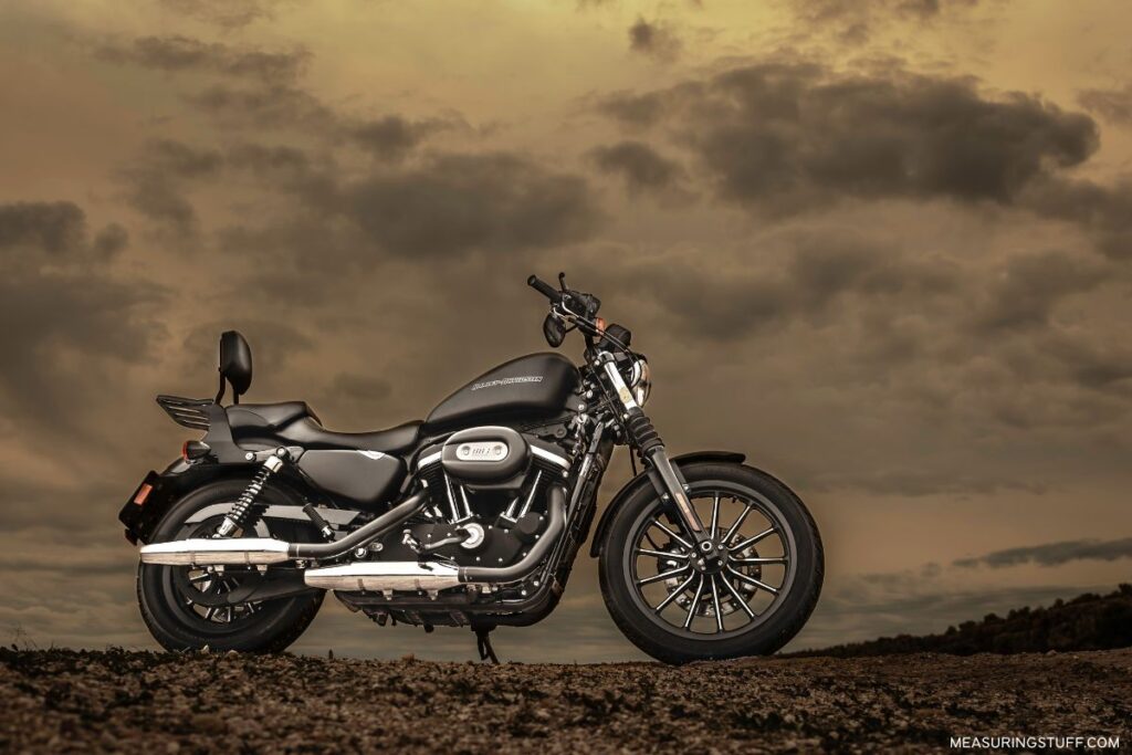 motorcycle parked on dirt on a cloudy day