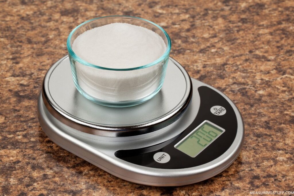 cup of sugar on a scale that weighs 206 grams