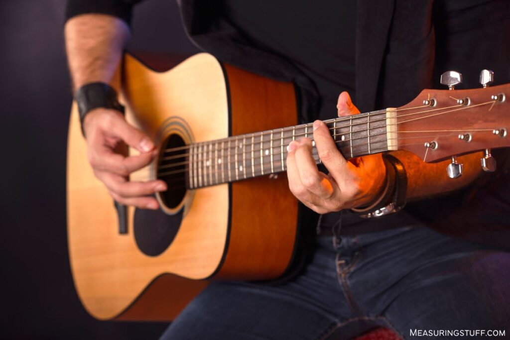 man playing an acoustic guitar