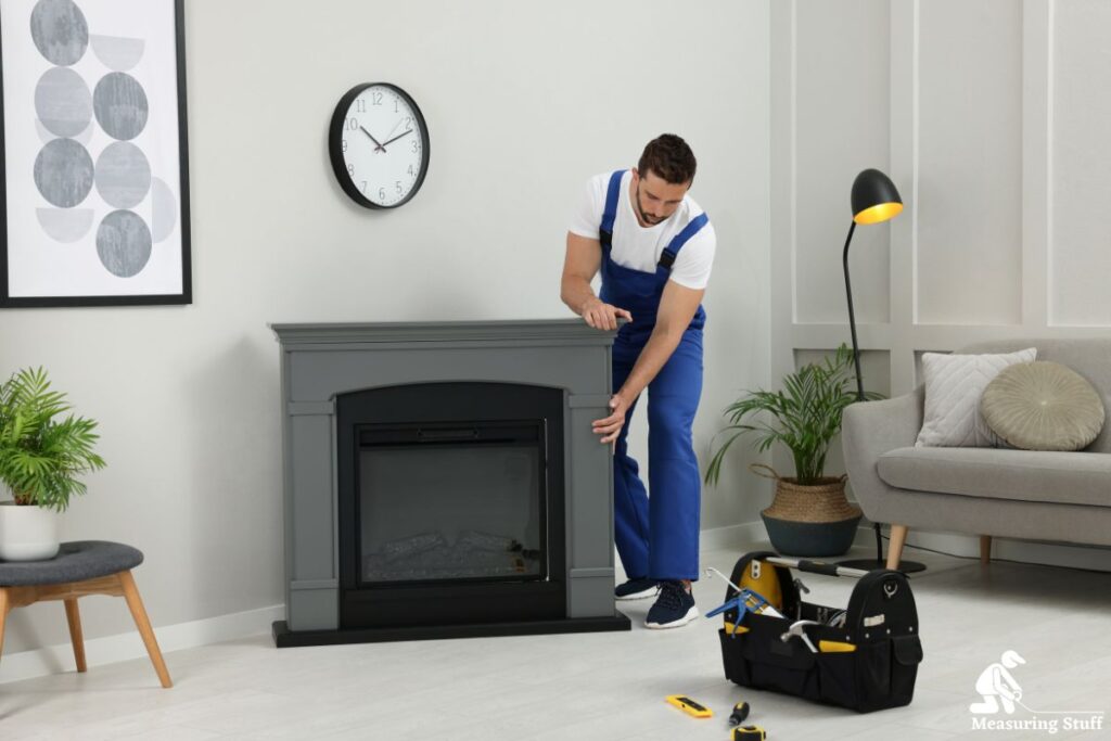 man installing an electric fireplace
