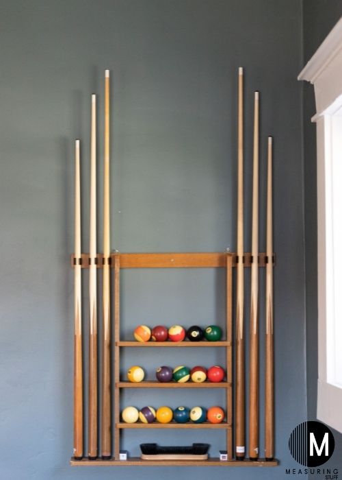 pool cues on wall rack