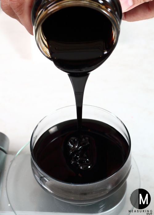 pouring molasses into a glass dish