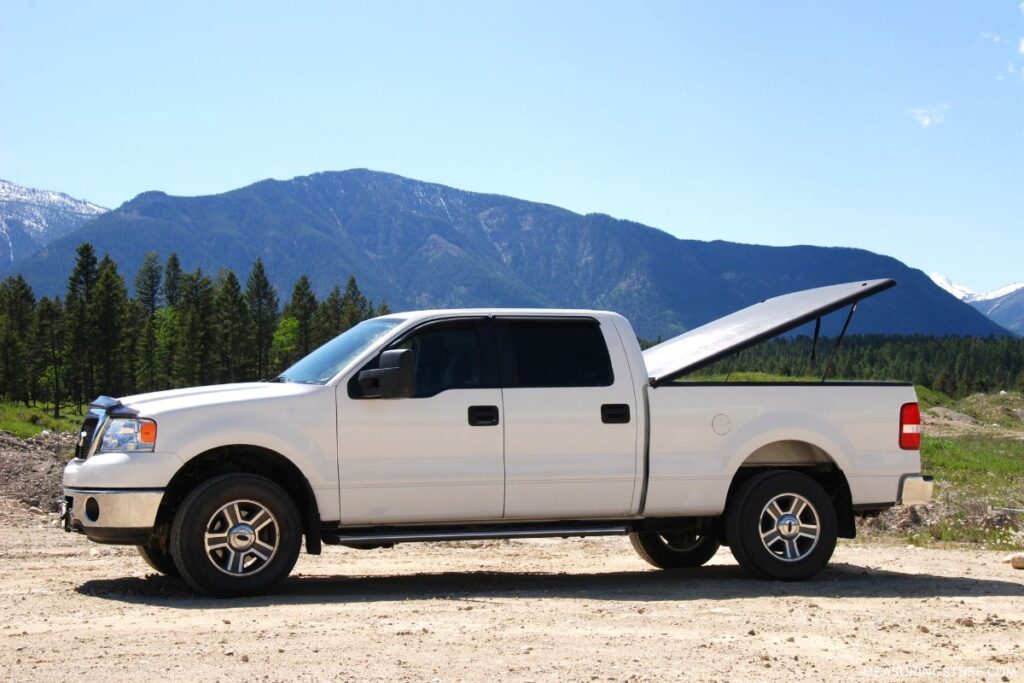 white pickup truck with open box cover